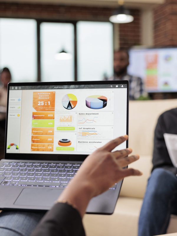 African american business people analyzing company charts and diagrams on laptop to create startup presentation and paperwork report. Doing teamwork collaboration to plan research information.