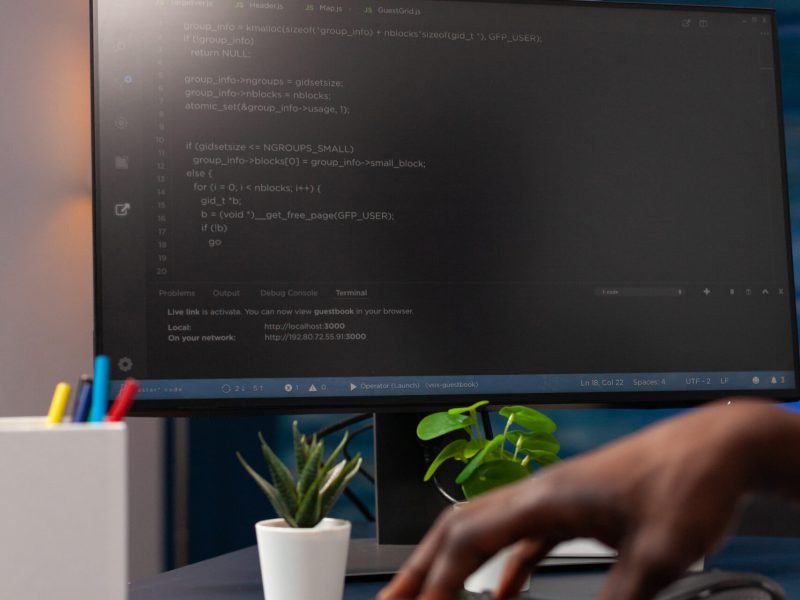 Closeup of programmer man hand typing website script on computer working remote from home. African american hacker worker programming binary code using network security system. Concept of coding